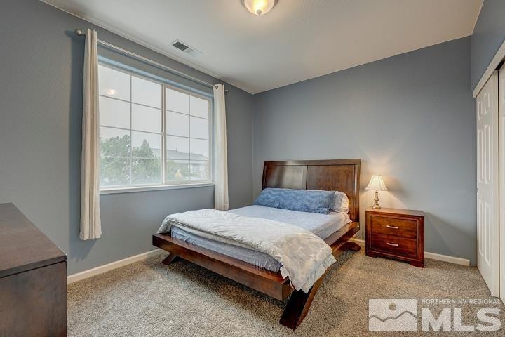 10520 Baton Court Reno, NV 89521 - Photo 29 of 38 a bedroom with a bed lamp and a window