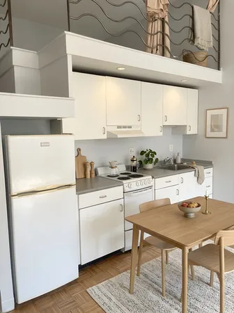 a kitchen with a table chairs and a refrigerator