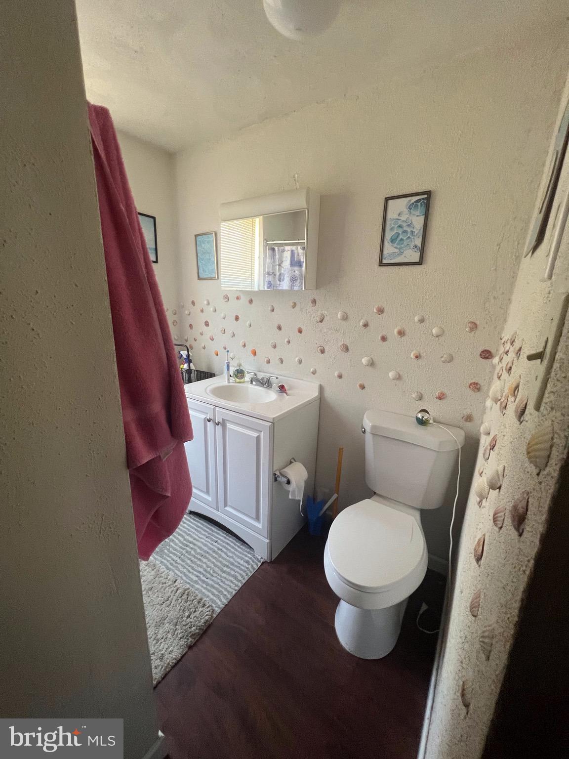 2834 East Venango Street Philadelphia, PA 19134 - Photo 5 of 10 a bathroom with a toilet a sink and mirror