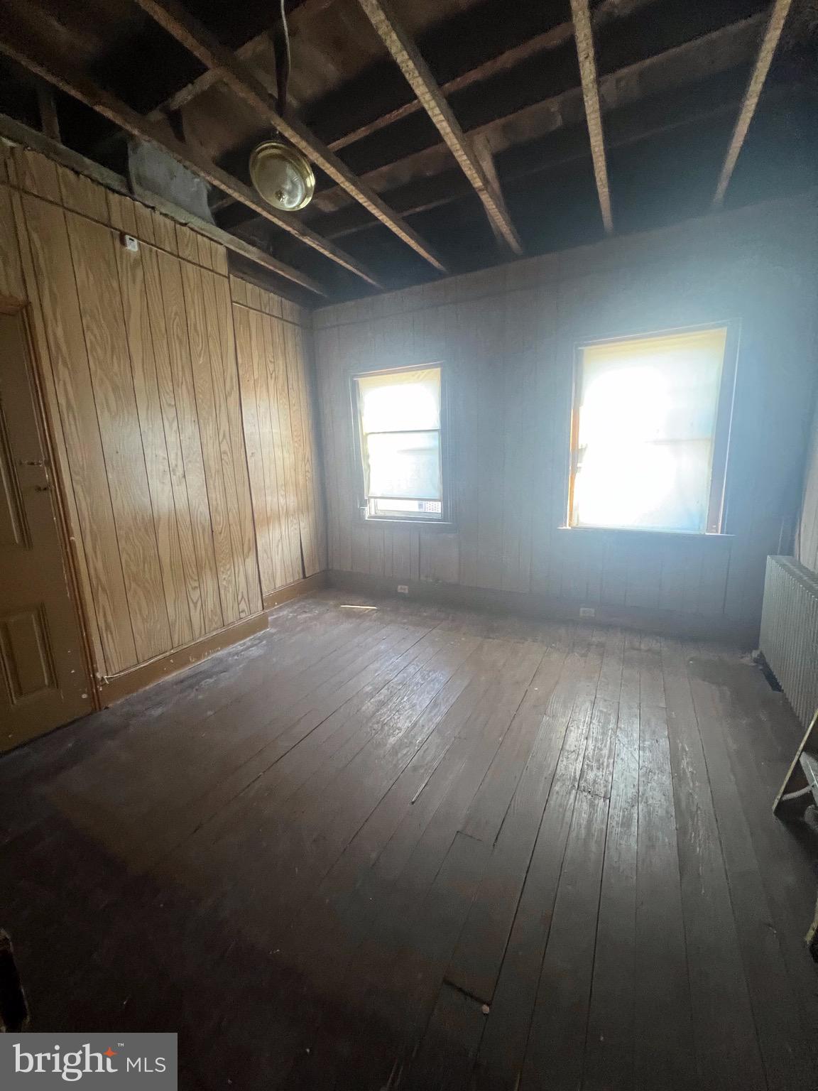 2834 East Venango Street Philadelphia, PA 19134 - Photo 9 of 10 an empty room with wooden floor and windows