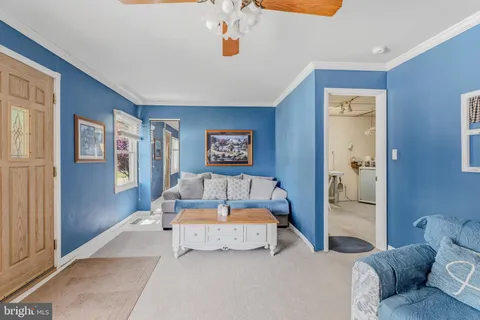 a bedroom with a large bed and ceiling fan