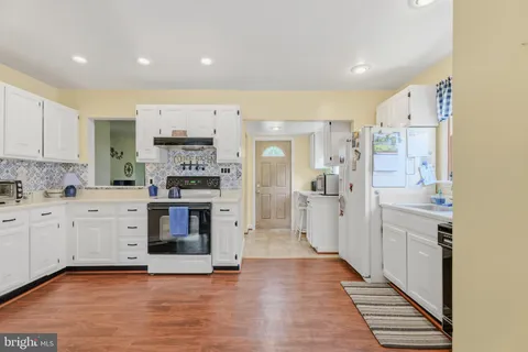 a kitchen with stainless steel appliances a stove a sink and a refrigerator