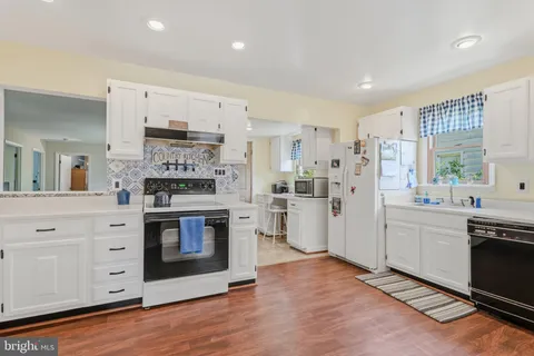 a kitchen with stainless steel appliances a stove a sink and a refrigerator