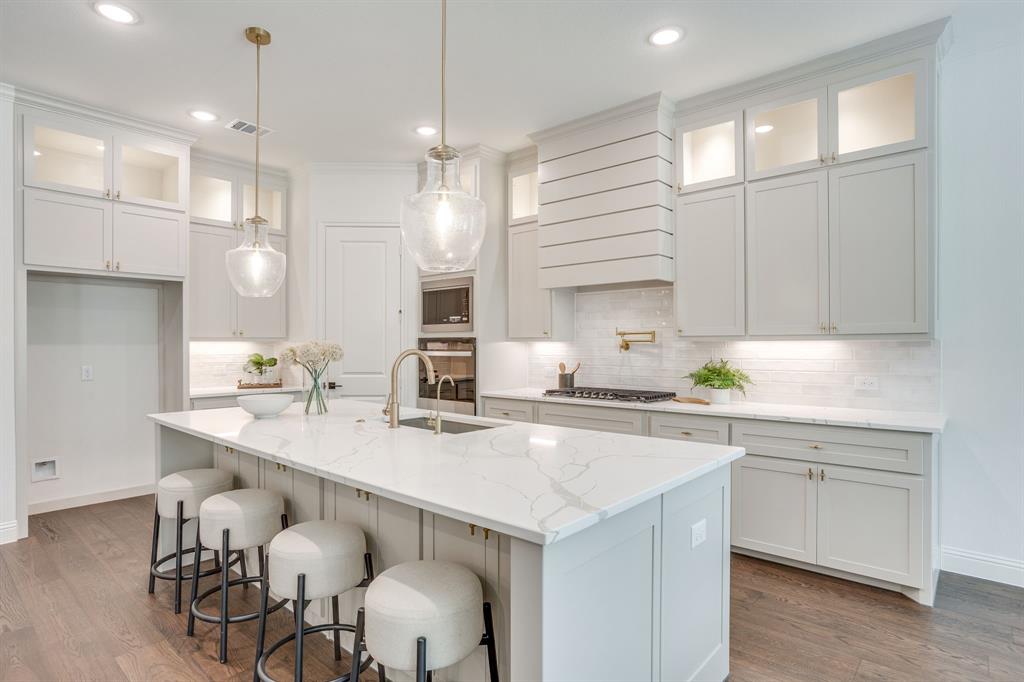 608 Tay Tay Way Springtown, TX 76082 - Photo 13 of 40 Kitchen featuring a central island with countertop, shaker-style cabinetry, wood-finish flooring, recessed lighting, and pendant light fixtures