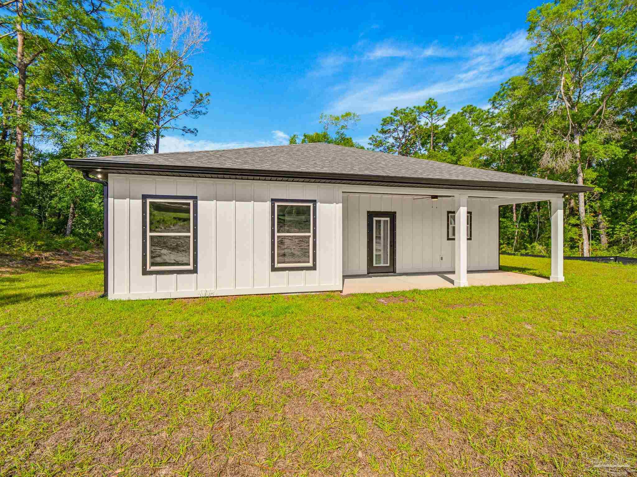 5724 Riviera Drive Milton, FL 32583 - Photo 49 of 52 a view of a house with pool and garden