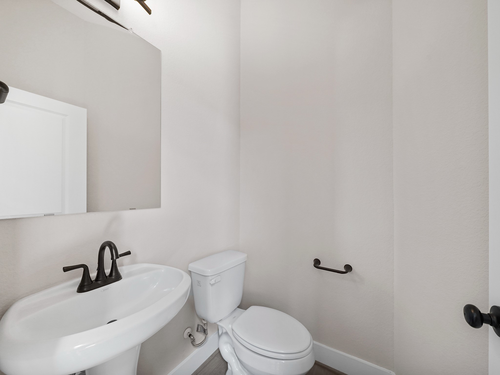 30214 Crossfield Road Fulshear, TX 77441 - Photo 6 of 42 A beautifully finished powder bath is conveniently located nearby for guests.