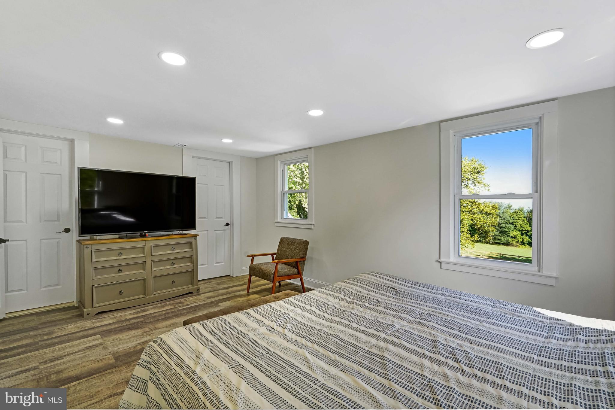 27100 Ridge Road Damascus, MD 20872 - Photo 30 of 74 a bedroom with a bed and a flat screen tv