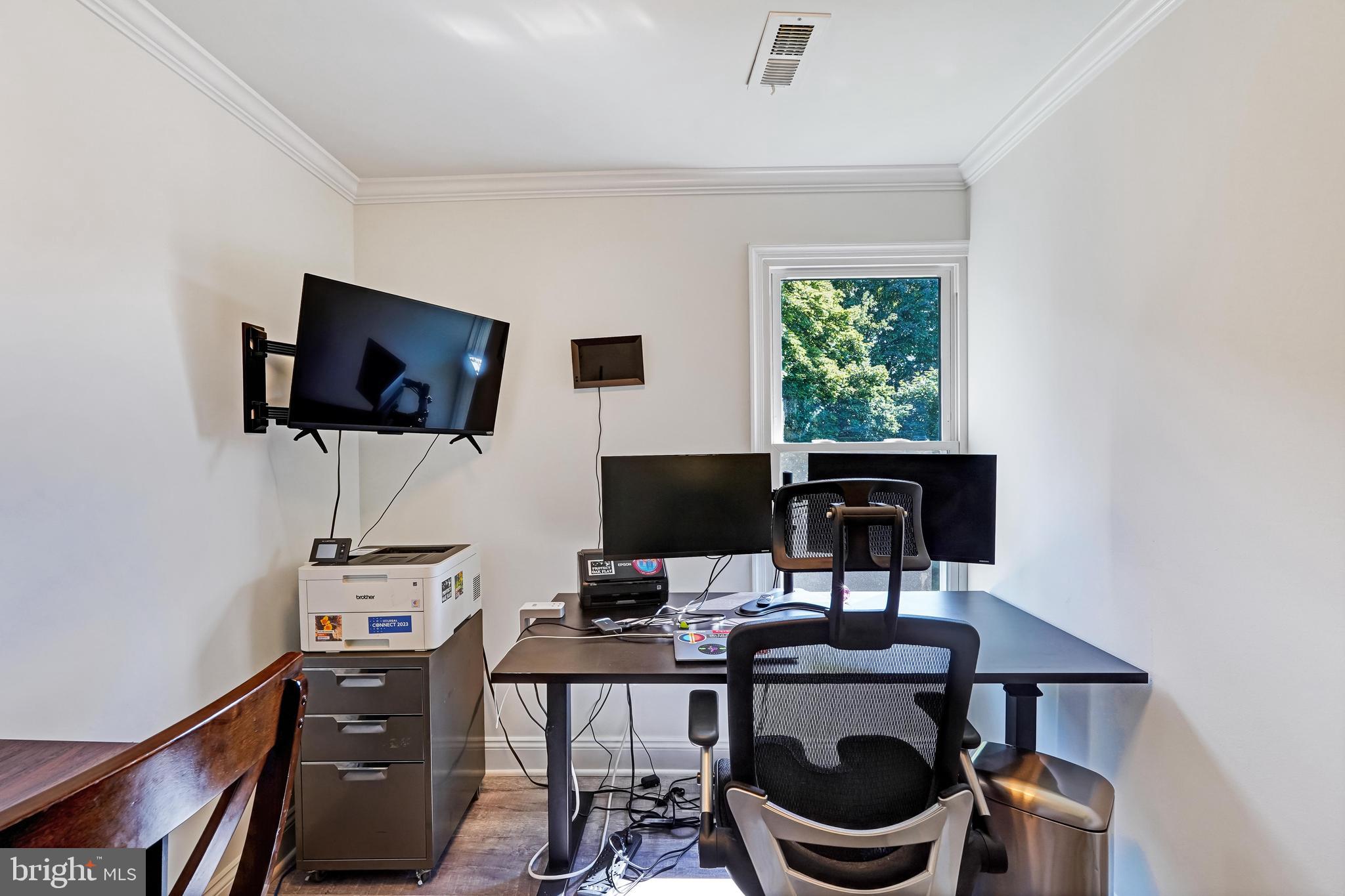 27100 Ridge Road Damascus, MD 20872 - Photo 40 of 74 a work room with furniture a flat screen tv and a window