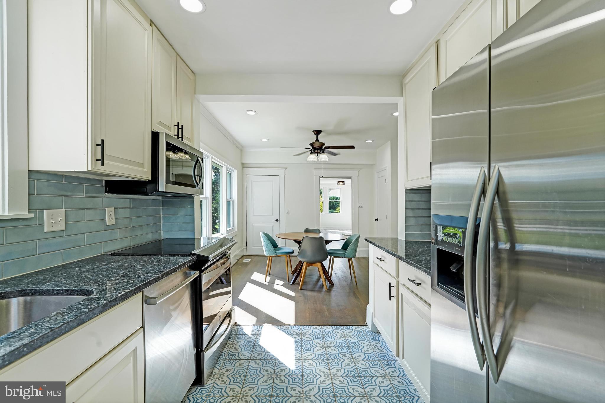 27100 Ridge Road Damascus, MD 20872 - Photo 5 of 74 a kitchen with stainless steel appliances granite countertop a refrigerator a stove and a sink with granite countertops