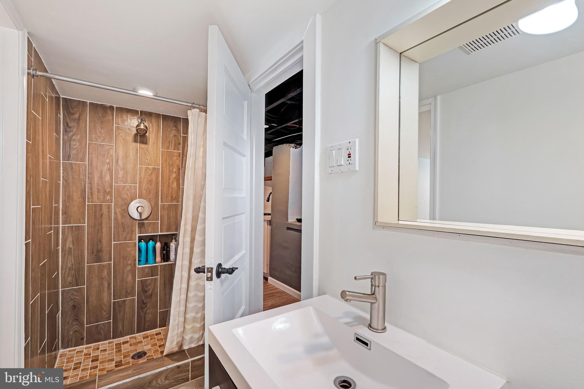 27100 Ridge Road Damascus, MD 20872 - Photo 57 of 74 a bathroom with a shower and a sink