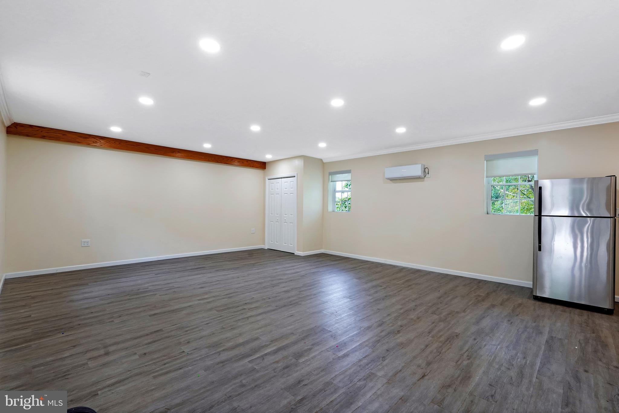 27100 Ridge Road Damascus, MD 20872 - Photo 61 of 74 an empty room with wooden floor and windows
