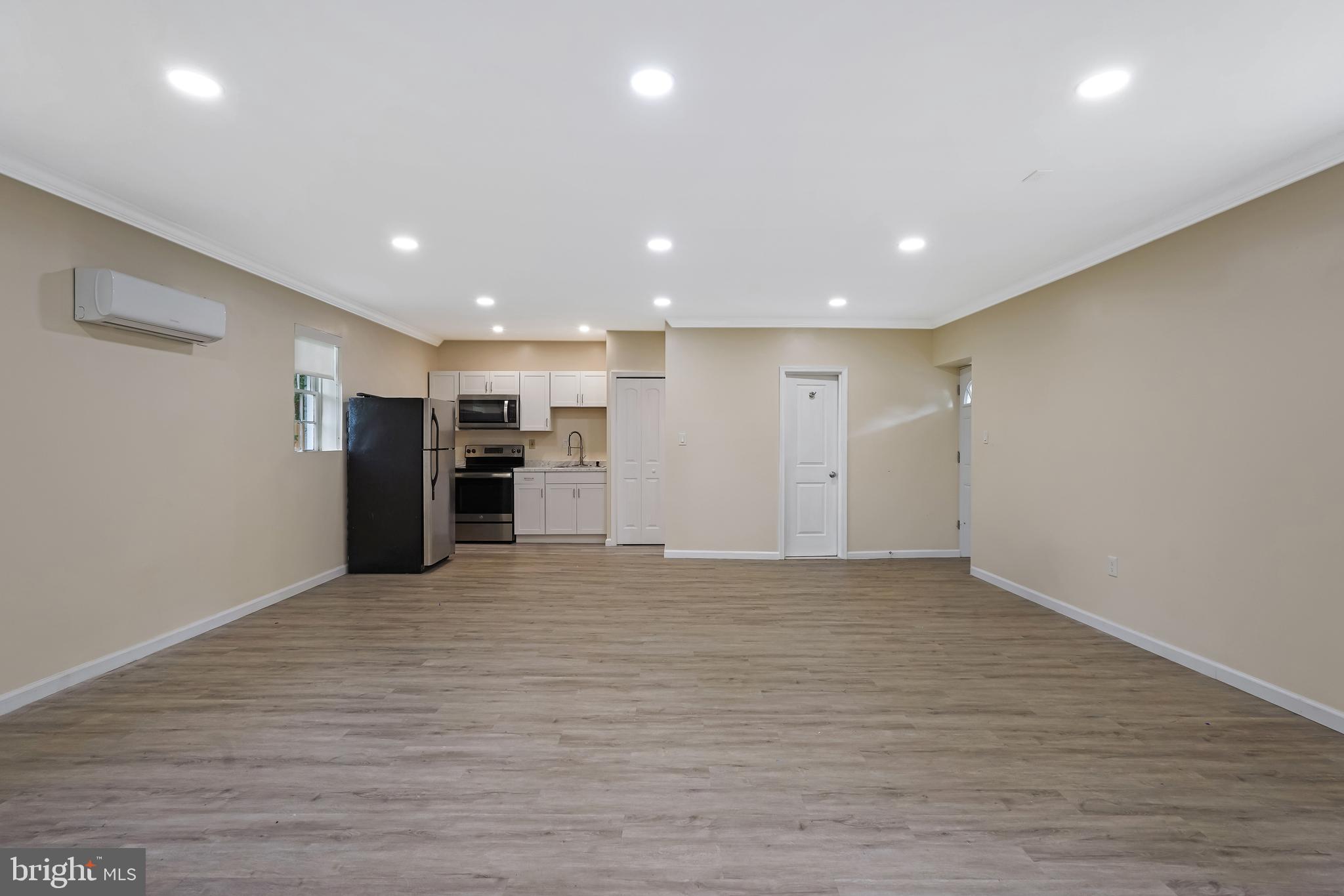 27100 Ridge Road Damascus, MD 20872 - Photo 62 of 74 a view of an empty room with wooden floor