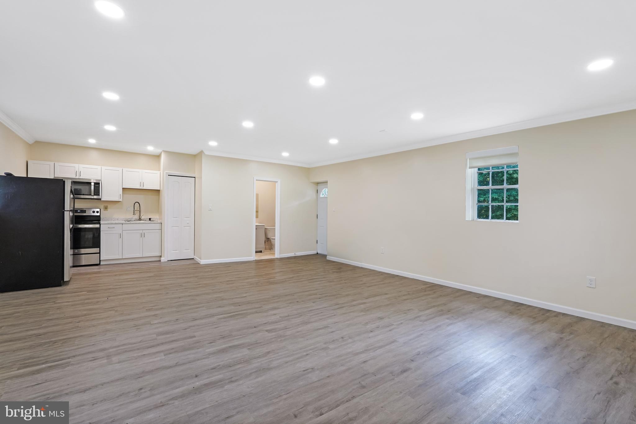 27100 Ridge Road Damascus, MD 20872 - Photo 63 of 74 a view of an empty room with wooden floor and a window