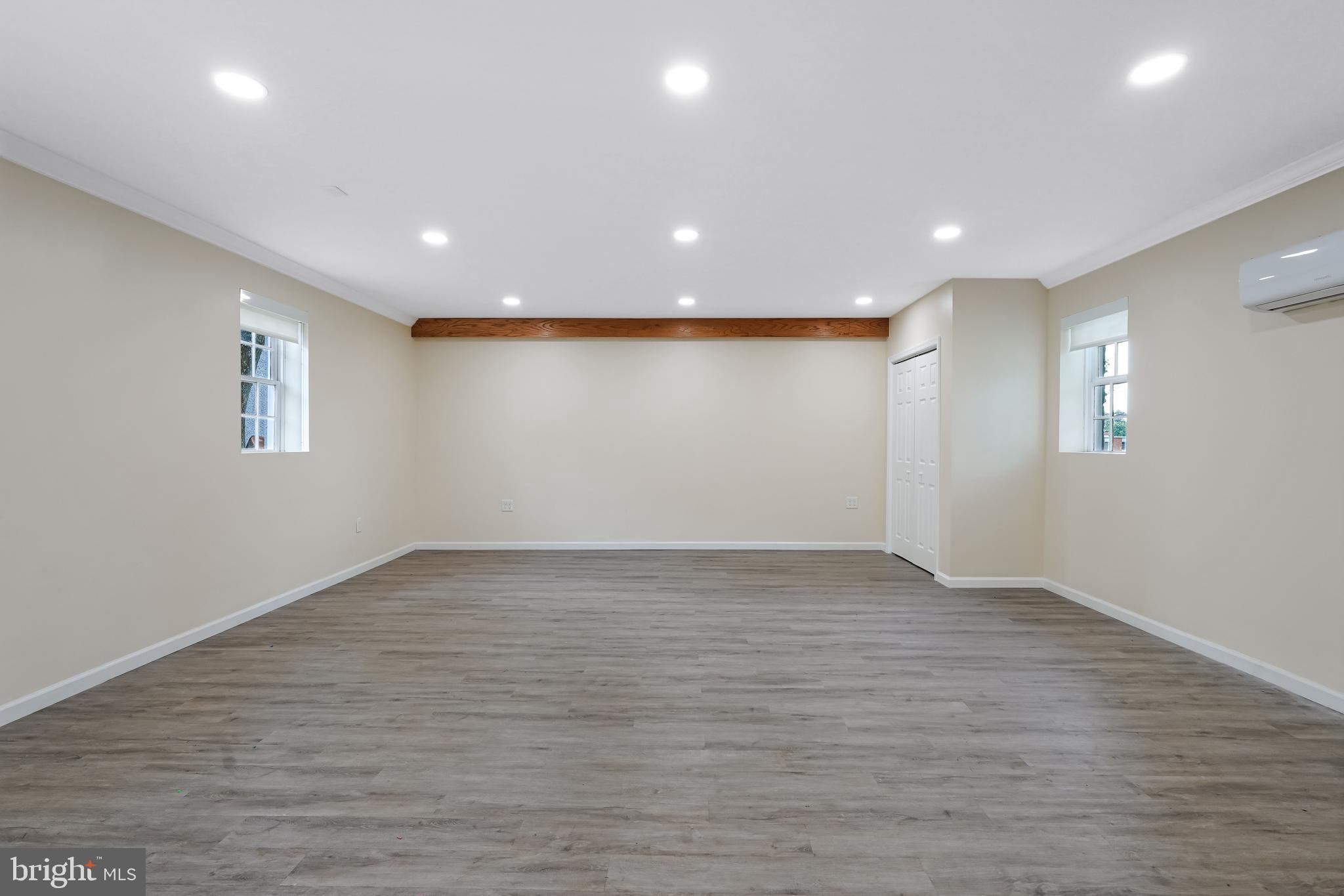27100 Ridge Road Damascus, MD 20872 - Photo 64 of 74 a view of an empty room with wooden floor and a window