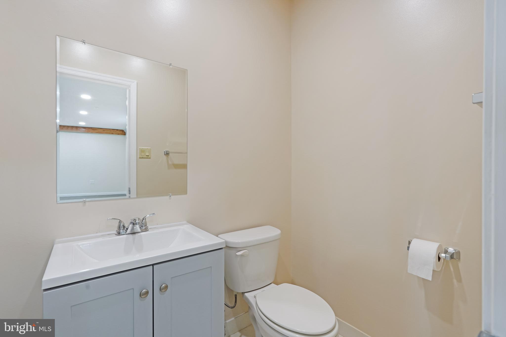 27100 Ridge Road Damascus, MD 20872 - Photo 66 of 74 a bathroom with a sink mirror and toilet