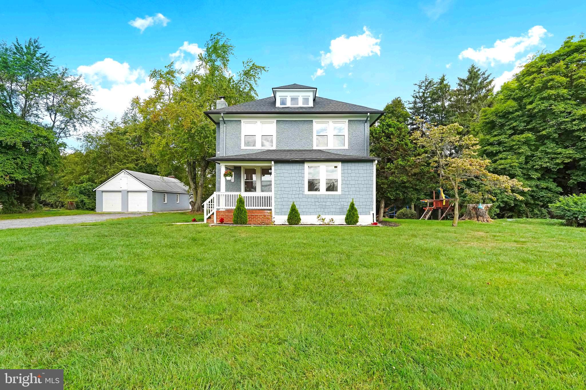 27100 Ridge Road Damascus, MD 20872 - Photo 68 of 74 a front view of a house with a yard and trees