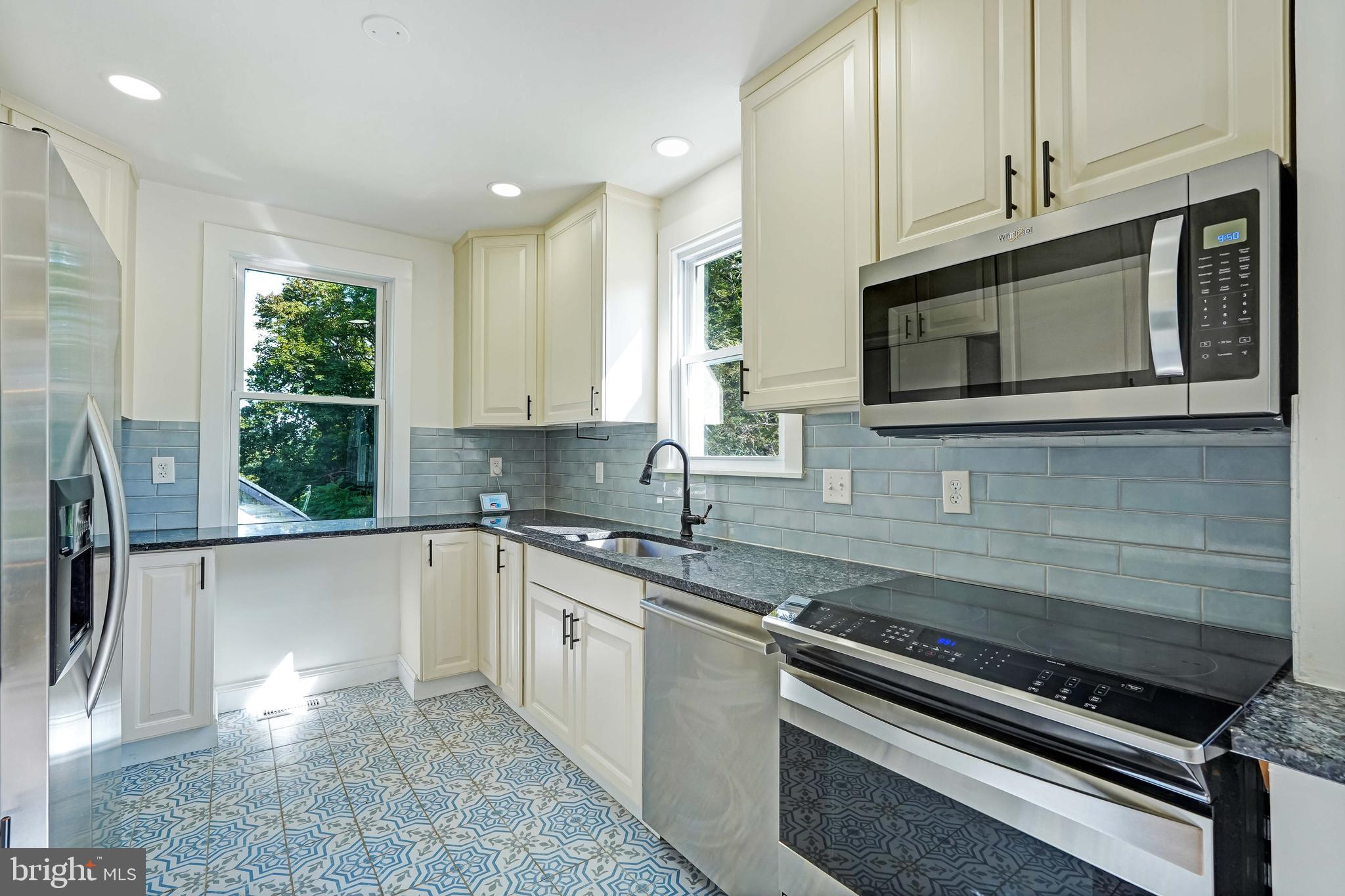 27100 Ridge Road Damascus, MD 20872 - Photo 8 of 74 a kitchen with stainless steel appliances granite countertop a sink and a stove