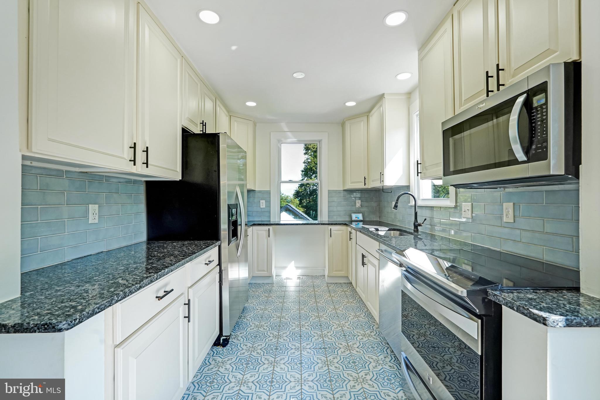 27100 Ridge Road Damascus, MD 20872 - Photo 9 of 74 a large kitchen with stainless steel appliances granite countertop a sink stove and microwave