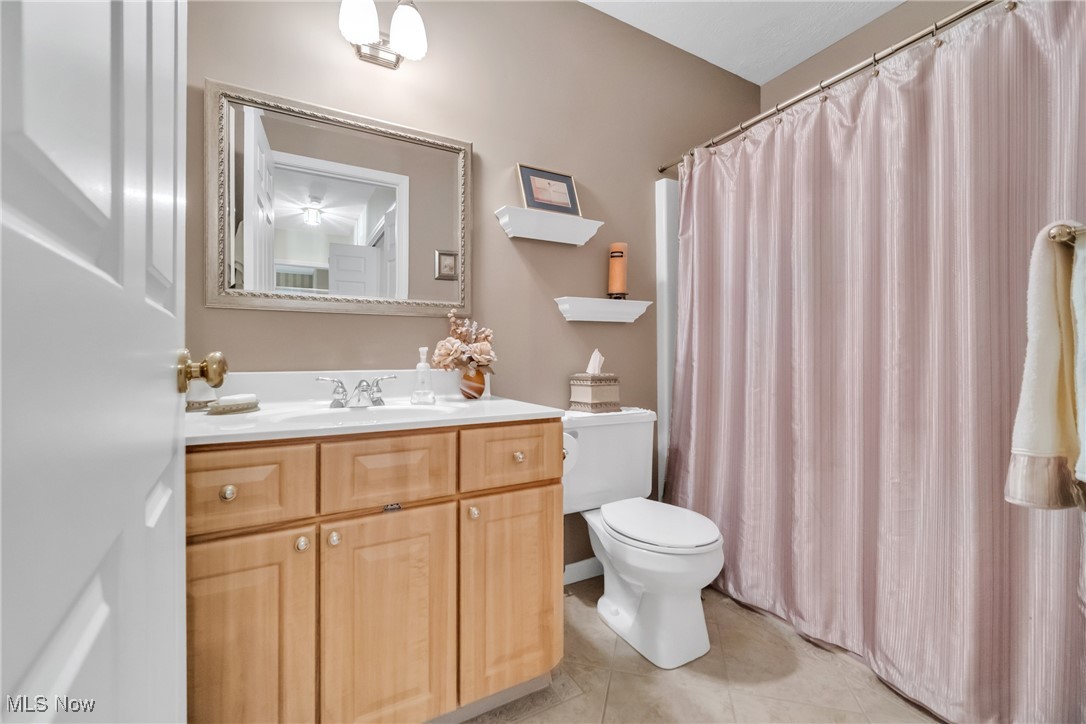 22481 Center Ridge Road, Unit 202 Rocky River, OH 44116 - Photo 15 of 24 Bathroom featuring vanity, toilet, and tile patterned floors