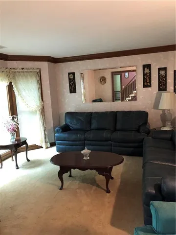 a living room with furniture and a piano