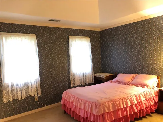 a bedroom with a bed and window