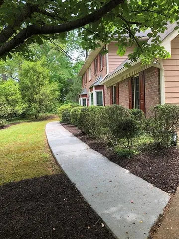 a front view of a house with garden