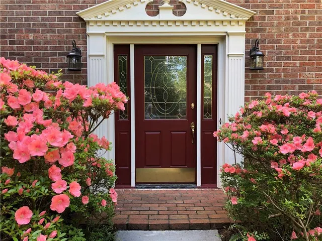 a front view of a house with flowers