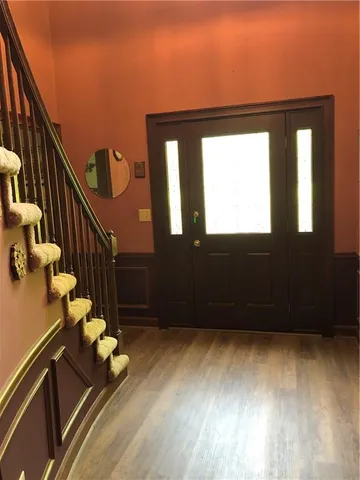 a view of entryway and hall with wooden floor