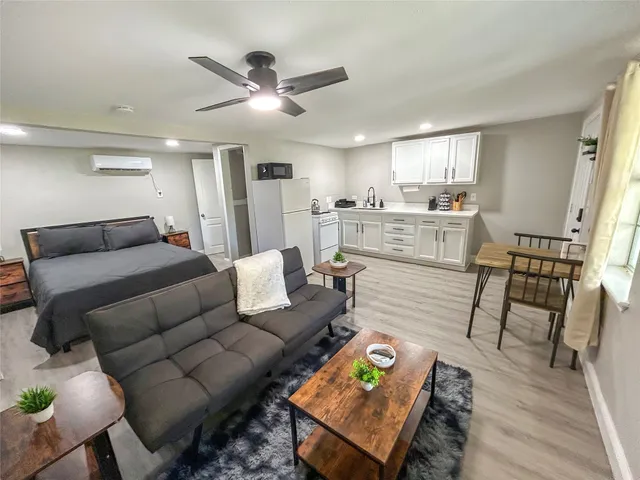 a living room with furniture and a wooden floor
