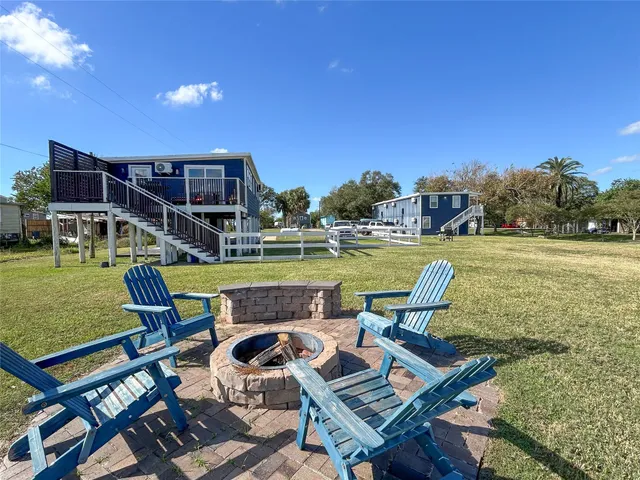 a view of a swimming pool and lounge chairs in back yard