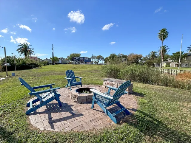 a view of a backyard with sitting area