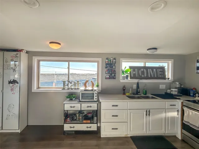 a kitchen with a refrigerator and window