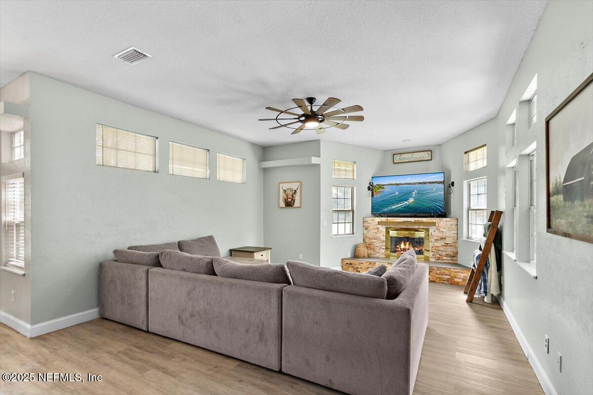 55214 Yellow Jacket Drive Callahan, FL 32011 - Photo 12 of 32 a living room with furniture and a flat screen tv
