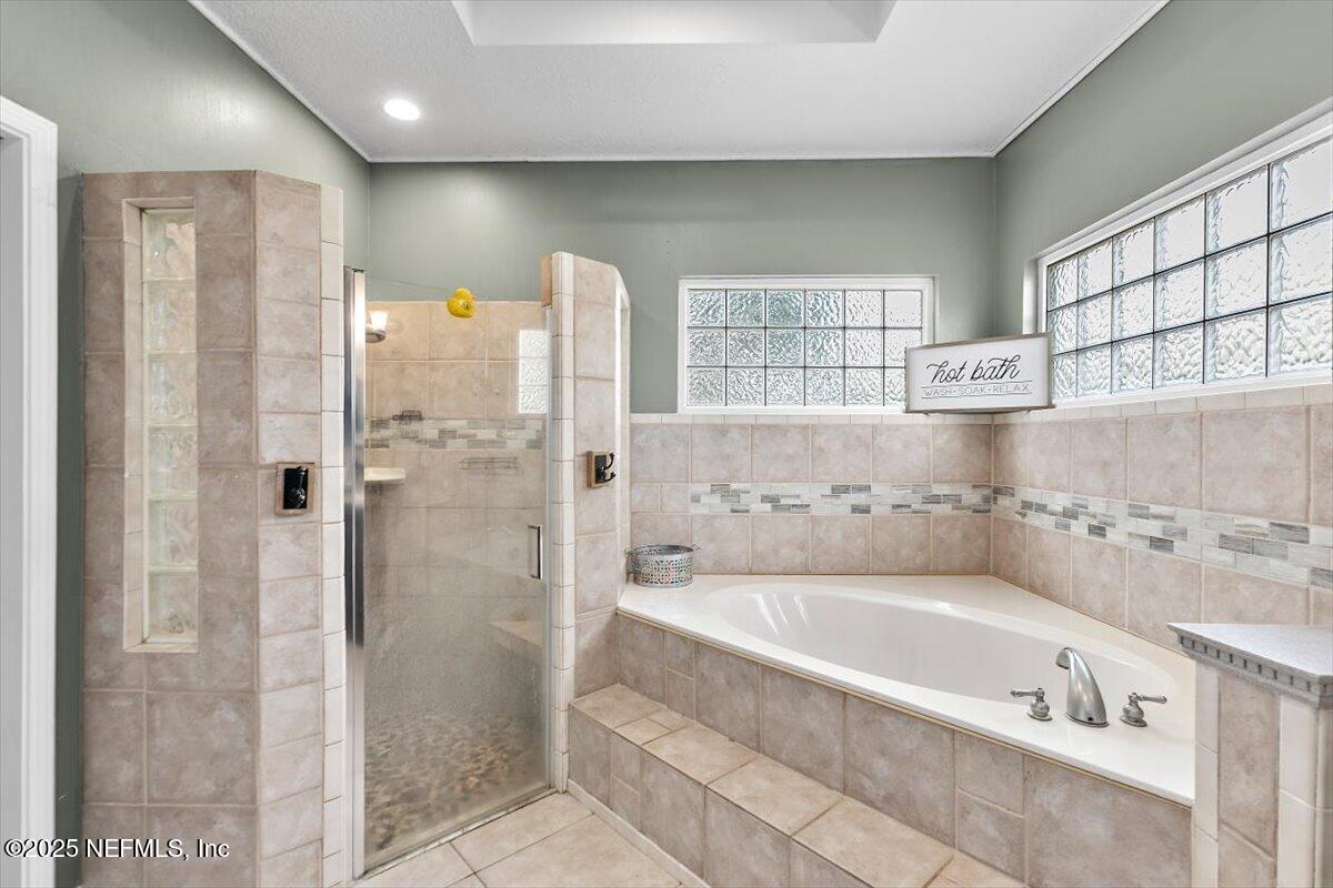 55214 Yellow Jacket Drive Callahan, FL 32011 - Photo 15 of 32 a bathroom with a bathtub and shower