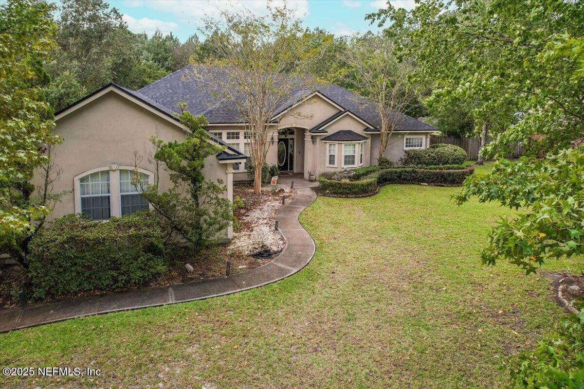 55214 Yellow Jacket Drive Callahan, FL 32011 - Photo 2 of 32 a front view of house with yard and green space