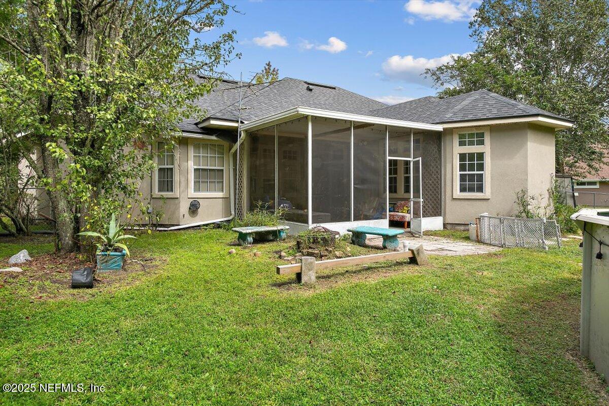 55214 Yellow Jacket Drive Callahan, FL 32011 - Photo 25 of 32 a view of a house with backyard sitting area and garden