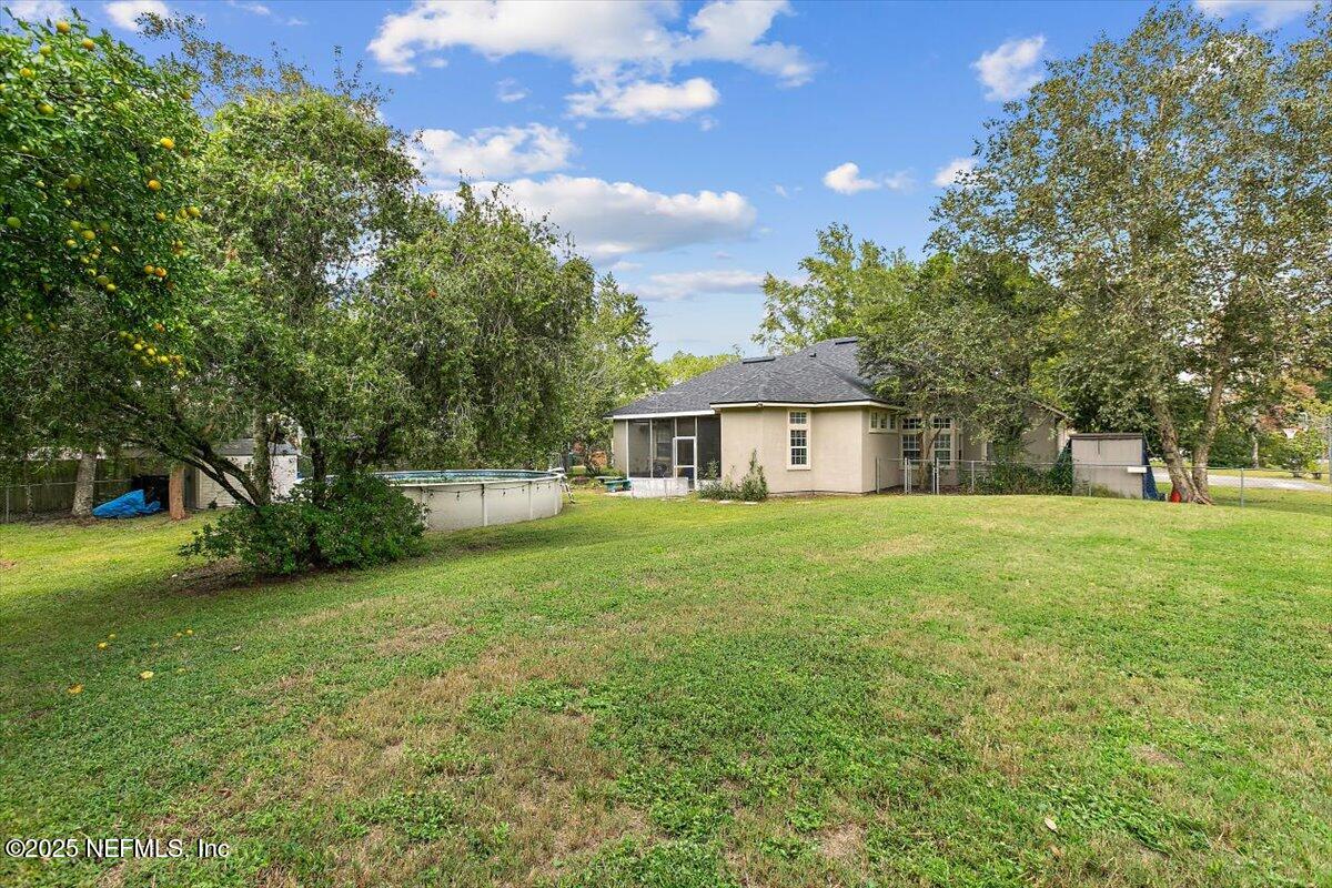 55214 Yellow Jacket Drive Callahan, FL 32011 - Photo 28 of 32 a front view of a house with a garden