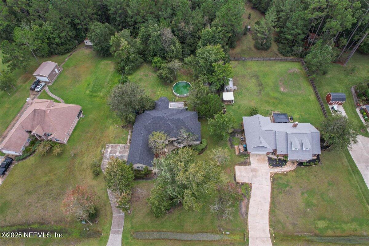 55214 Yellow Jacket Drive Callahan, FL 32011 - Photo 32 of 32 an aerial view of a house with outdoor space and a lake view