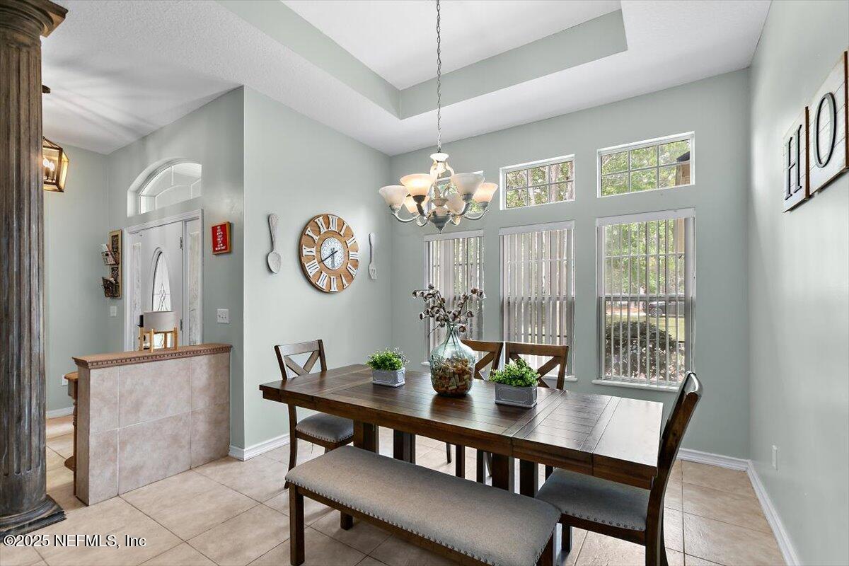 55214 Yellow Jacket Drive Callahan, FL 32011 - Photo 5 of 32 a view of a dining room with furniture a chandelier and wooden floor
