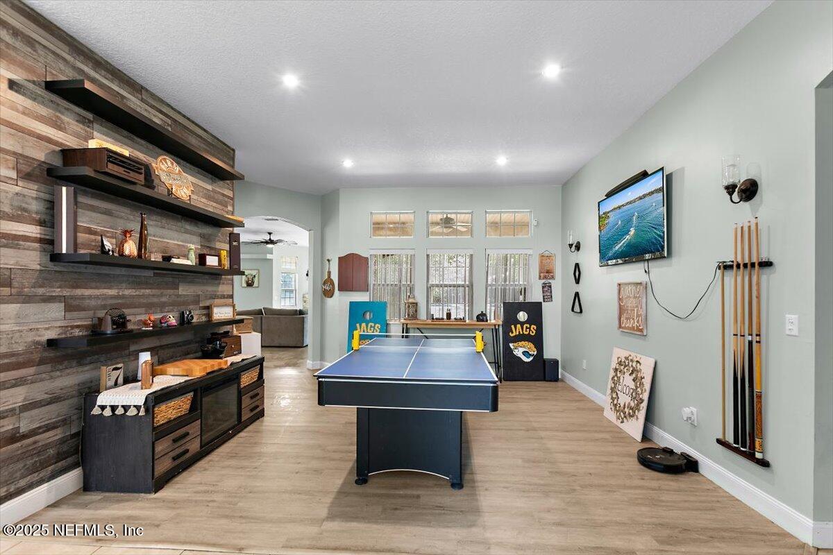 55214 Yellow Jacket Drive Callahan, FL 32011 - Photo 6 of 32 a room with stainless steel appliances lots of furniture and wooden floor