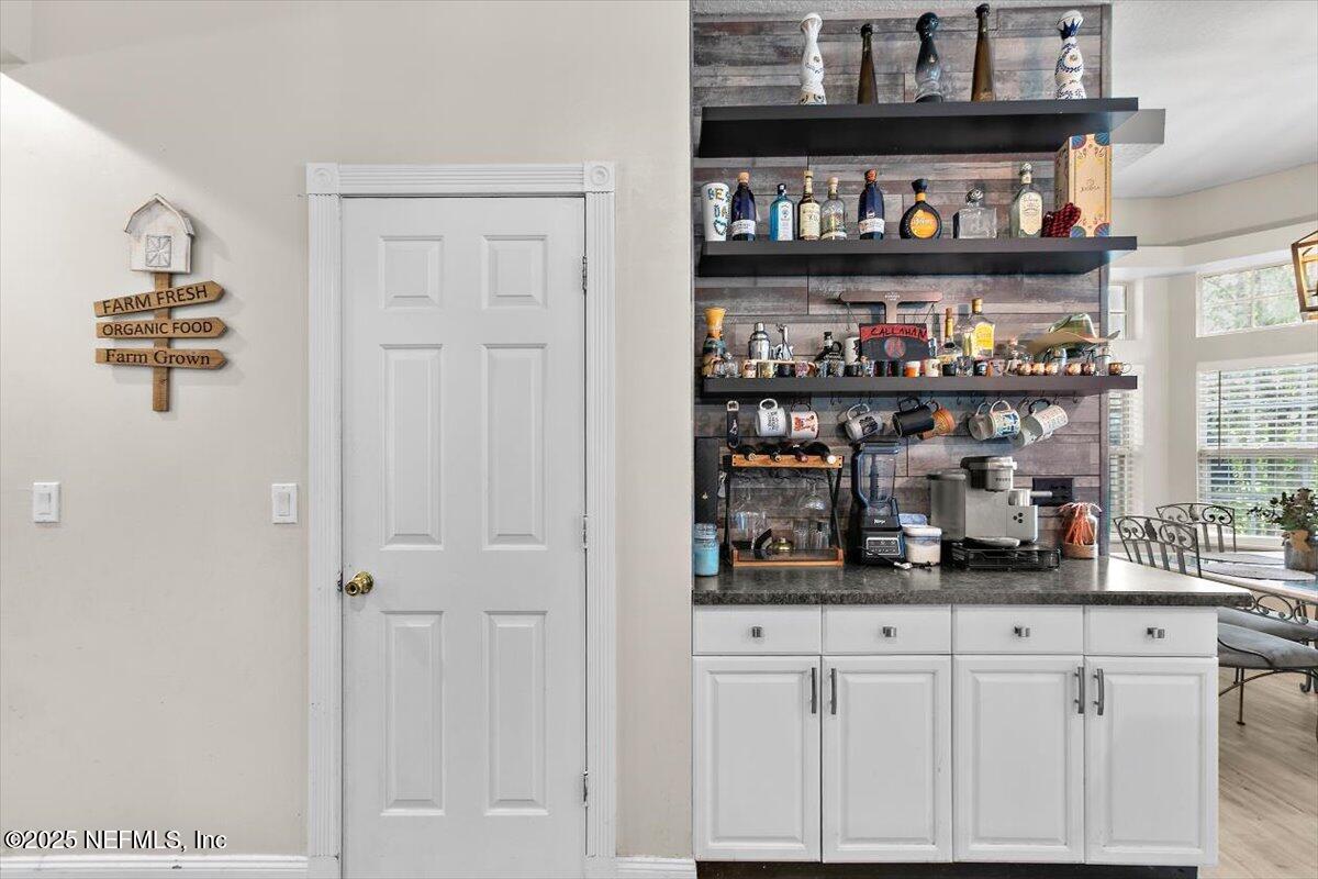 55214 Yellow Jacket Drive Callahan, FL 32011 - Photo 9 of 32 a kitchen with white cabinet and a refrigerator