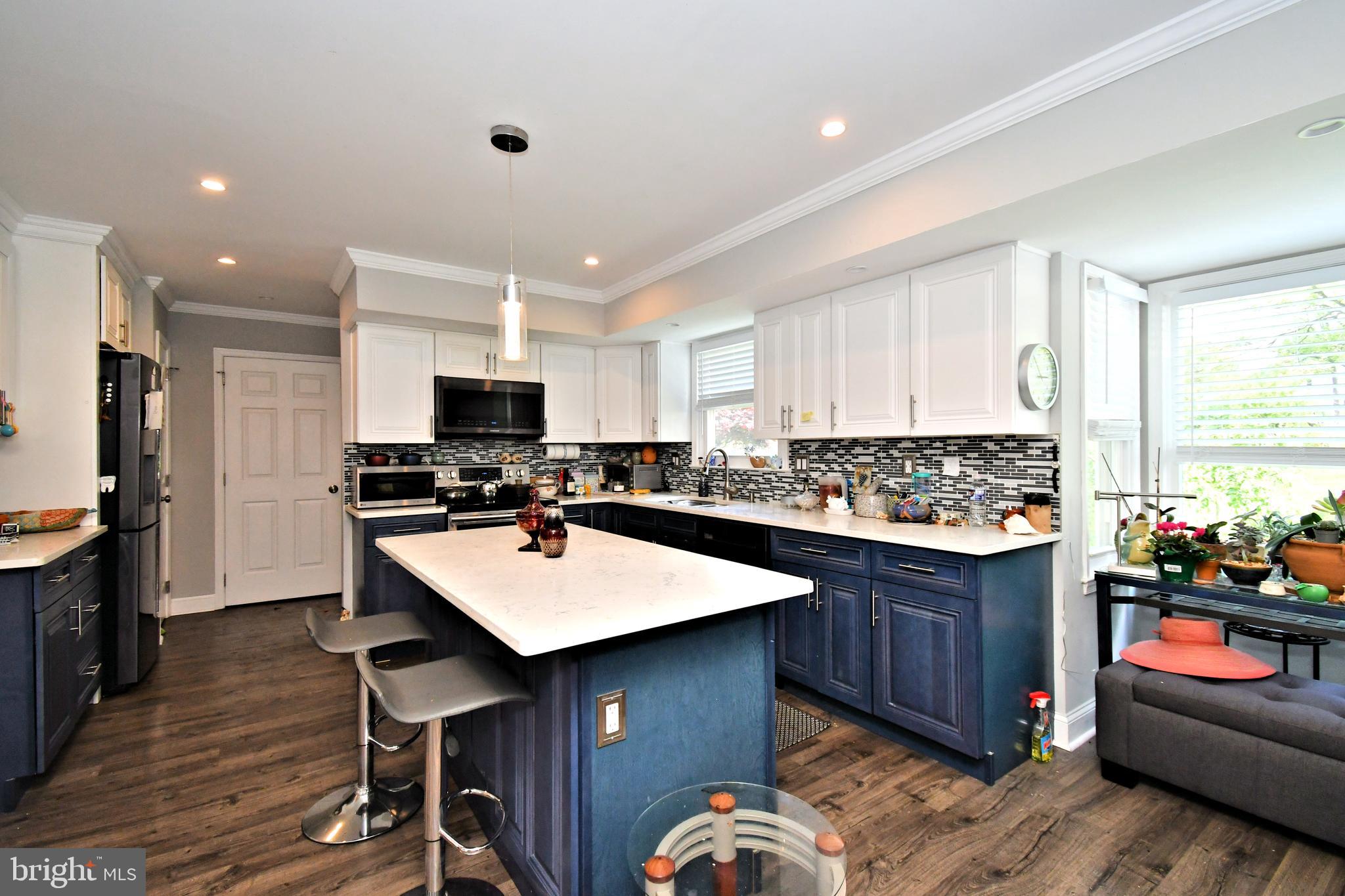 816 Glenn Circle Wayne, PA 19087 - Photo 15 of 63 a kitchen with stainless steel appliances granite countertop a table chairs sink refrigerator and cabinets