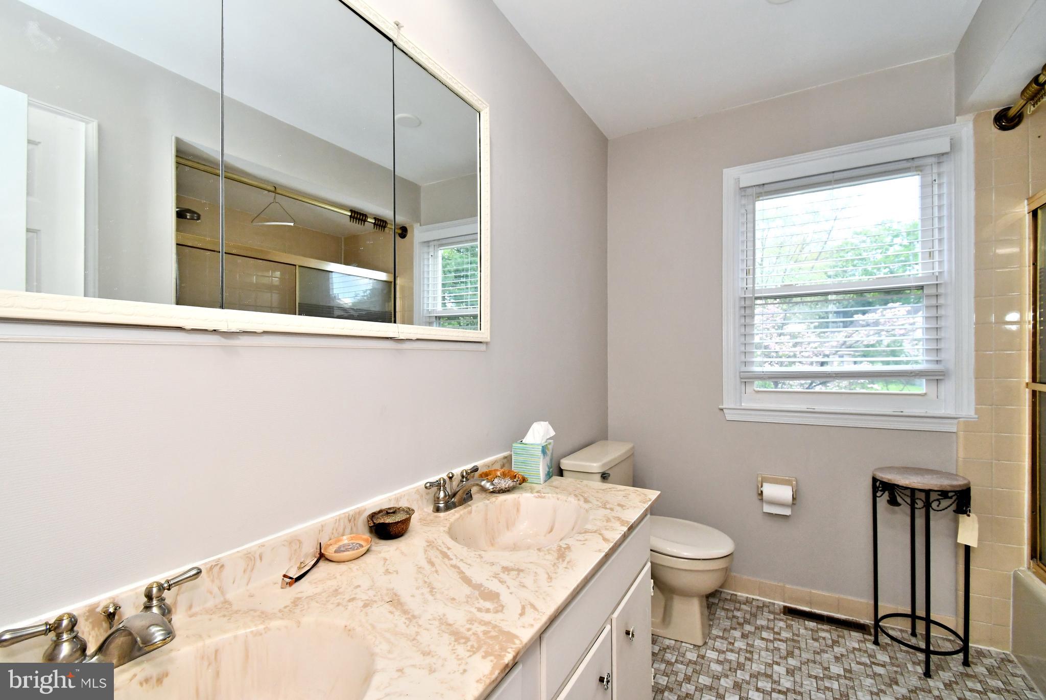 816 Glenn Circle Wayne, PA 19087 - Photo 39 of 63 a bathroom with a granite countertop sink toilet and mirror