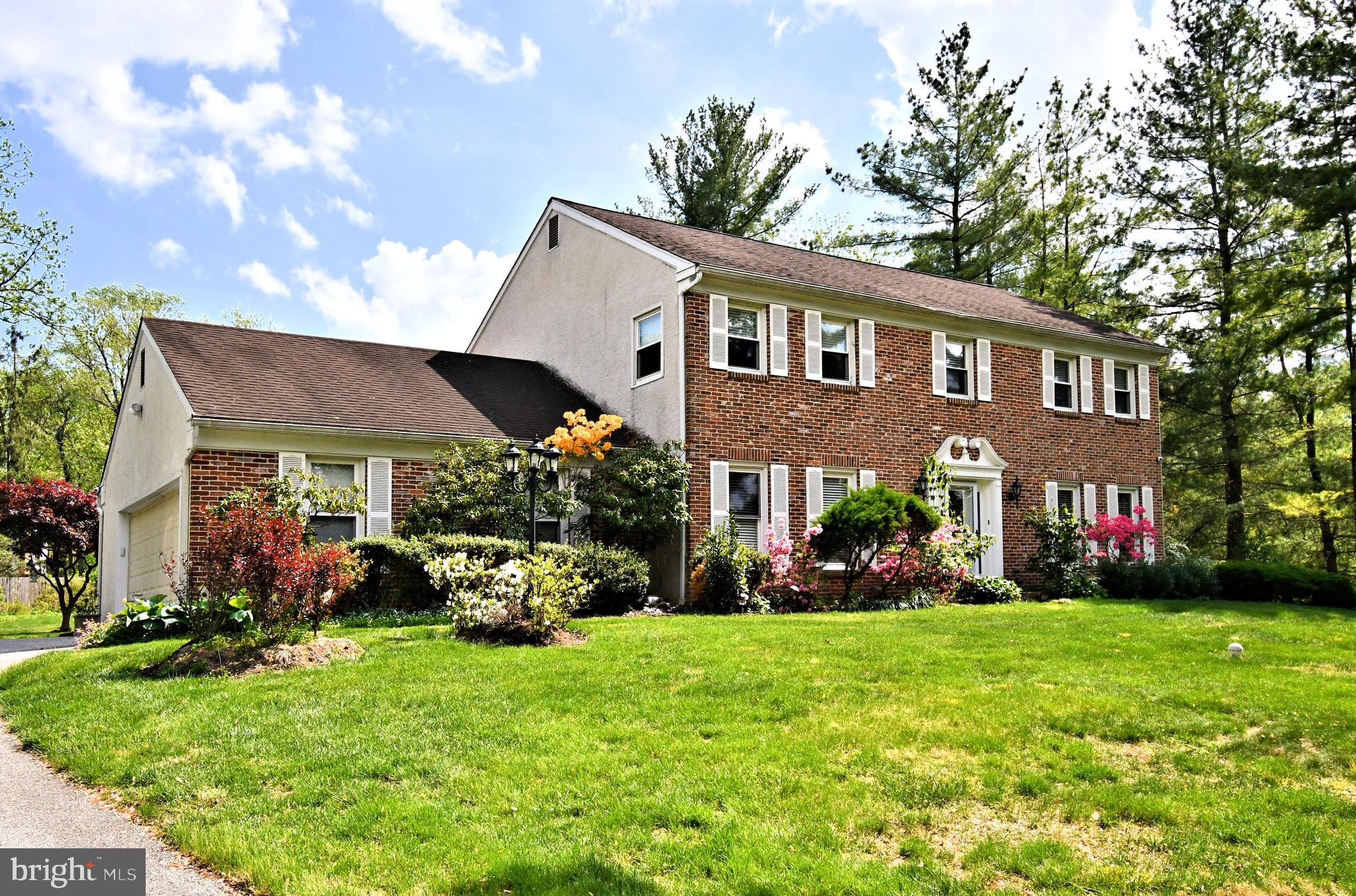 816 Glenn Circle Wayne, PA 19087 - Photo 4 of 63 a front view of a house with a garden and plants