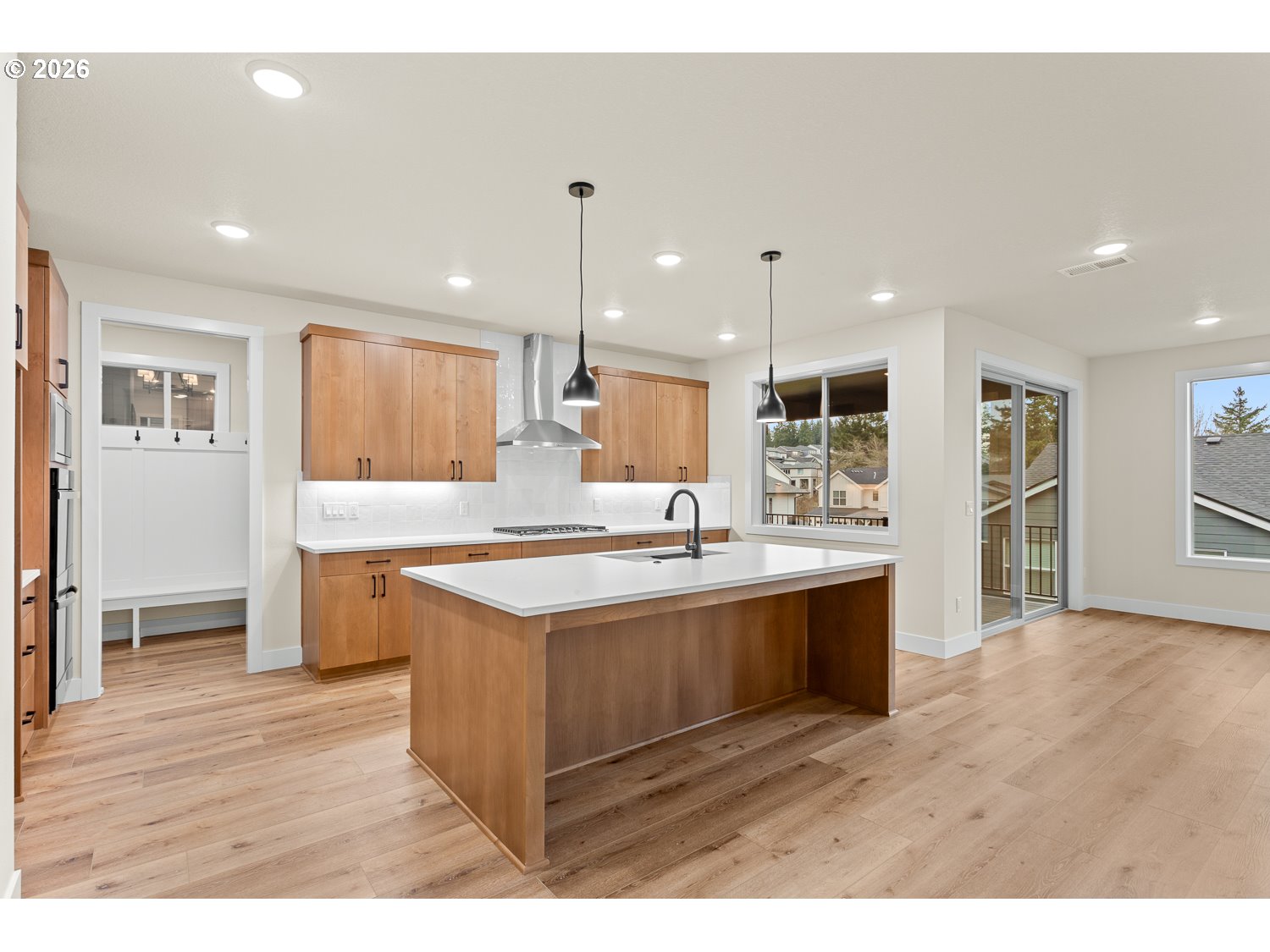 15666 Southwest Everglade Avenue Tigard, OR 97224 - Photo 12 of 45 a large kitchen with kitchen island a sink stainless steel appliances and cabinets