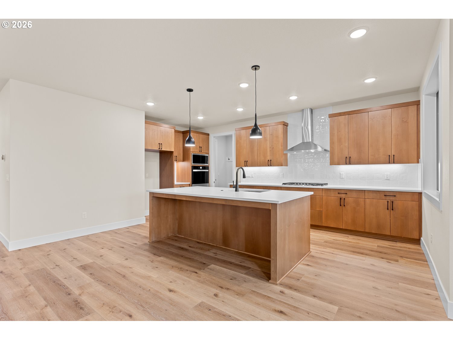 15666 Southwest Everglade Avenue Tigard, OR 97224 - Photo 14 of 45 a large kitchen with a large counter top a sink stainless steel appliances and cabinets