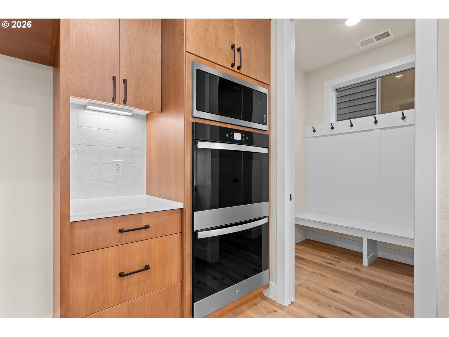 15666 Southwest Everglade Avenue Tigard, OR 97224 - Photo 18 of 45 a kitchen with white cabinets and stainless steel appliances