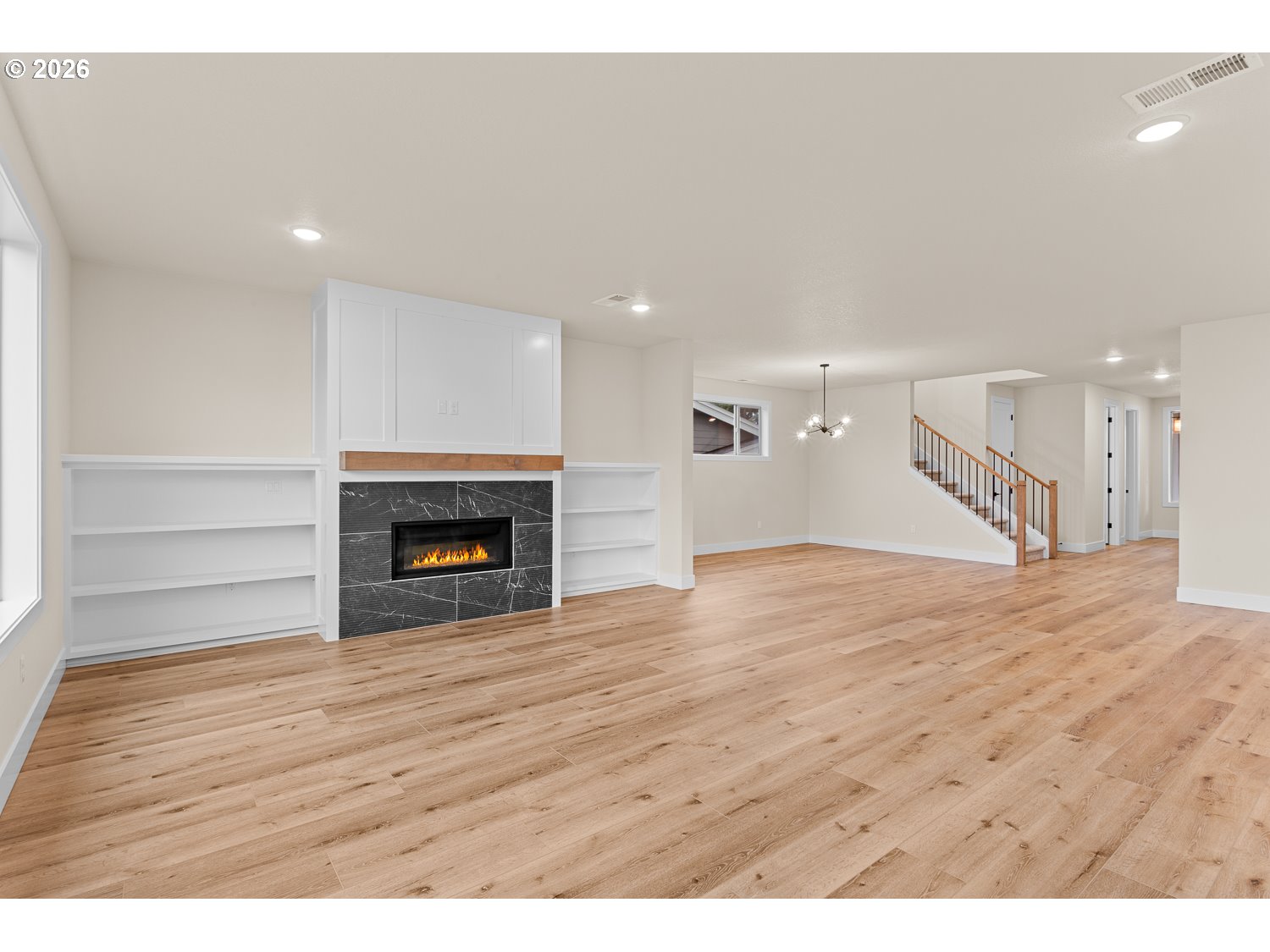 15666 Southwest Everglade Avenue Tigard, OR 97224 - Photo 21 of 45 a view of empty room with wooden floor and fireplace