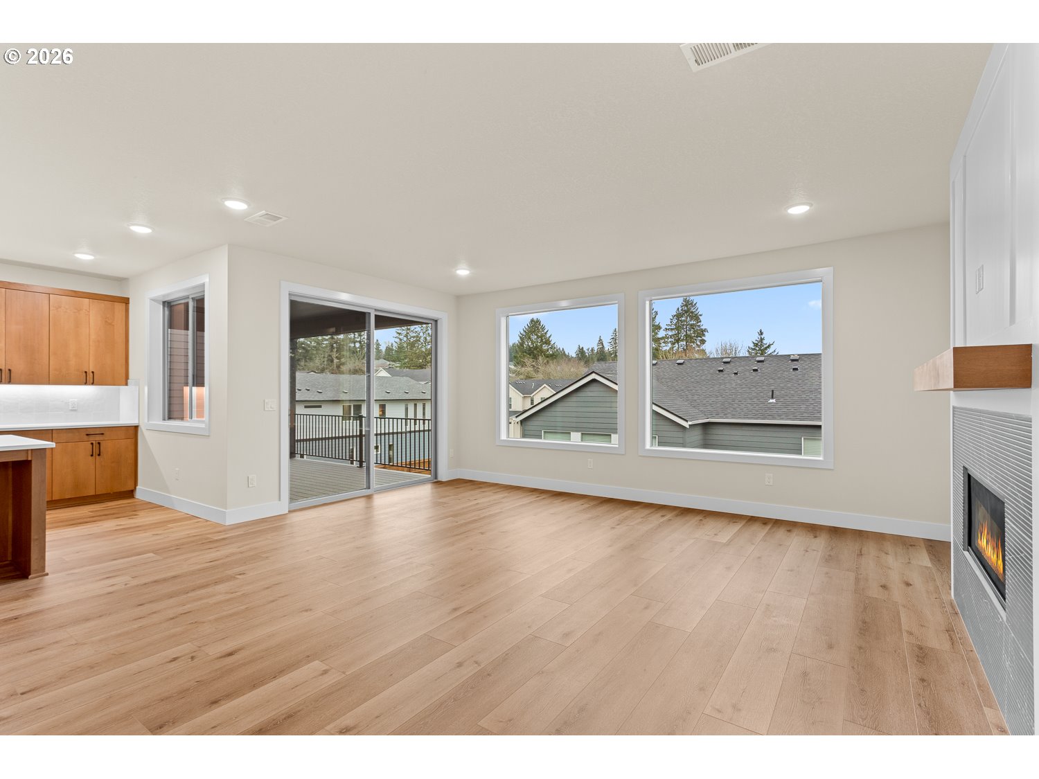 15666 Southwest Everglade Avenue Tigard, OR 97224 - Photo 22 of 45 a view of an empty room with a window and wooden floor