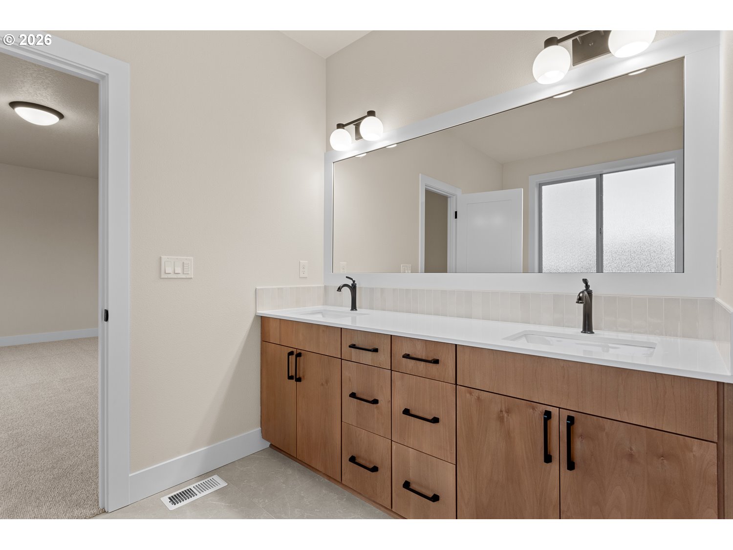 15666 Southwest Everglade Avenue Tigard, OR 97224 - Photo 29 of 45 a bathroom with a double vanity sink and a mirror